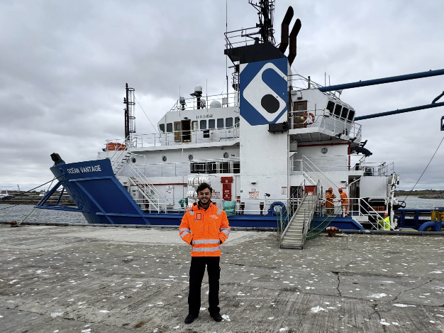 Photo of Nicholas Mackenley with a offshore marine vessel in the background.